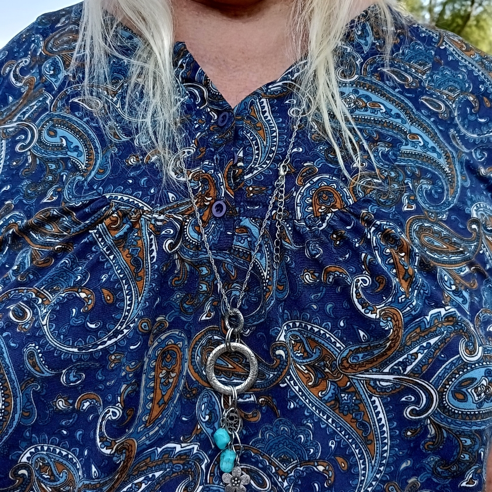 A silver style necklace with blue stones.